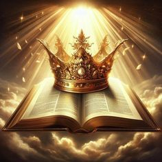 an open book with a crown on top of it in the clouds and sunbeams