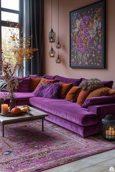 a living room filled with purple couches and lots of pillows on top of it