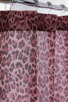 a leopard print curtain hanging from a metal rod