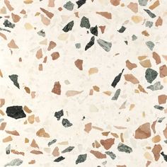 a white marble floor with brown and black speckles on the top, in an irregular pattern