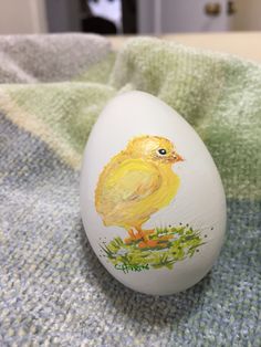 an egg with a painted chicken on it