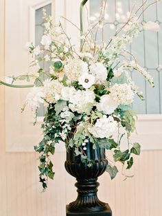 a vase filled with white flowers on top of a table