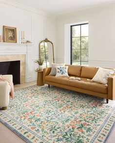 a living room filled with furniture and a fire place in front of a mirror on the wall