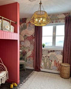 a bedroom with a bunk bed and colorful wallpaper on the walls next to a window