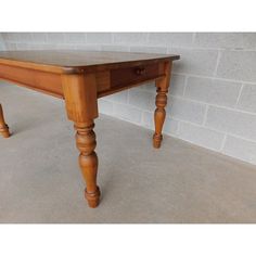 a wooden table sitting on top of a cement floor