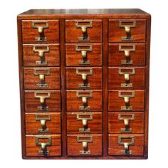 an old wooden file cabinet with many drawers and brass pulls on the doors, isolated against a white background