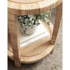 a plant is sitting on top of a wicker table with a potted plant