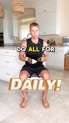 a man sitting on top of a kitchen counter