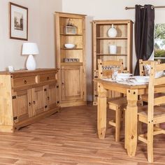 a wooden dining room table and chairs