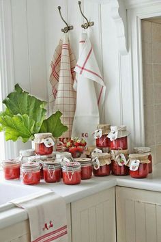 a kitchen counter topped with lots of jams and fruit on top of each other