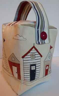 a small bag with houses on it sitting on a table