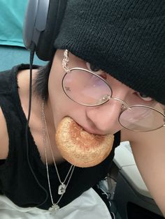 a person wearing headphones and eating a doughnut