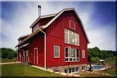 a red house with a pool in the yard