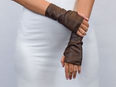 "Fingerless gloves made from qualitative and soft faux leather. Those hand warmers have a counter shape so they fit the hand in a comfy way. Thumbhole reinforced with stitching - makes it look neat. Labels are sewn on separately so you can remove them without damaging the garment. SIZE and MEASUREMENTS are given in the last picture. Those are REAL HAND measurements. The fabric is stretchy. To choose a size, please, pick the closest measurement AROUND KNUCKLES. After that, please check the other Art Refence, Medieval Gloves, Fantasy Gloves, Folds Reference, Fingerless Leather Gloves, Gloves Diy, Black Fingerless Gloves, Leather Fingerless Gloves, Brown Leather Gloves