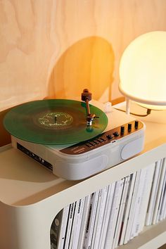 a record player sitting on top of a white shelf