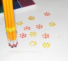 two yellow pencils sitting next to each other on top of a white tablecloth