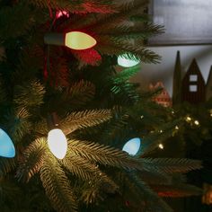 the christmas tree is decorated with colorful lights