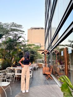 a woman is standing on the outside patio