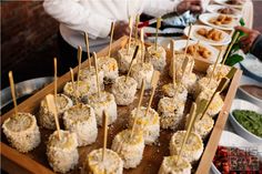 a wooden tray filled with food on top of a table next to other plates and bowls