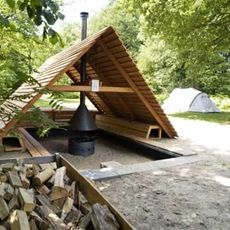 a wooden structure sitting in the middle of a forest