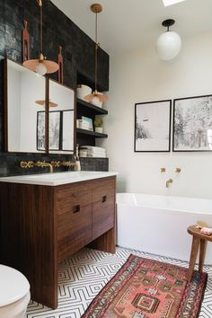 a bath room with a rug a sink and a toilet