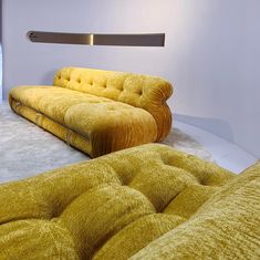 a yellow couch and chair in a room