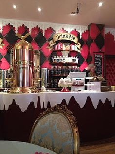 the interior of a restaurant with red and black wallpaper