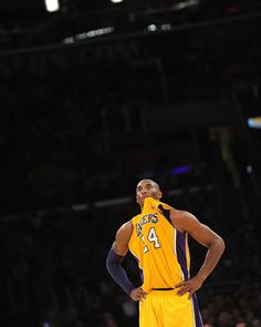 a basketball player standing on the court with his hands on his hips