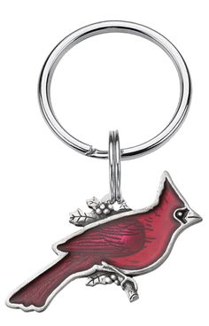 a metal key chain with a red bird on it