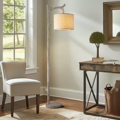 a living room with a lamp, chair and mirror