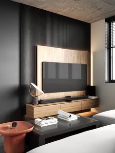 a modern living room with black walls and wood paneling on the wall, along with a large flat screen tv