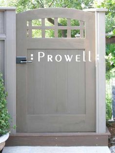 the front door is painted gray and has an advertisement on it that says prowell