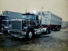 two semi trucks parked next to each other