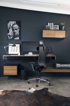 an office with a desk, chair and shelves on the wall is shown in this image