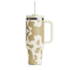 a coffee cup with a straw in it on a white background and an animal print pattern