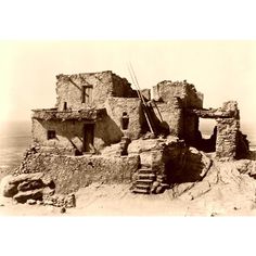 an old black and white photo of a building on top of a hill with stairs leading up to it