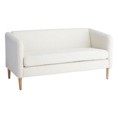 a white couch sitting on top of a wooden frame