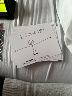 i love you cards are sitting on top of a bed