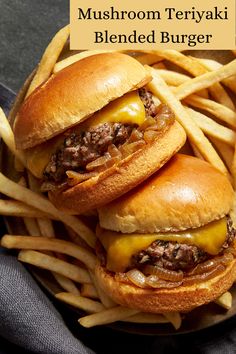 two cheeseburgers and french fries on a plate