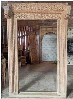 an ornate white marble fireplace surround in a room