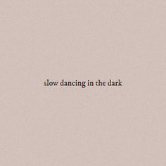 the words slow dancing in the dark are written on a gray background with black letters