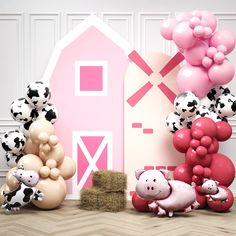 there are many balloons and farm animals in front of the barn with pink accents on it