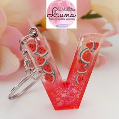 the letter v has watermelon slices on it and is attached to a keychain