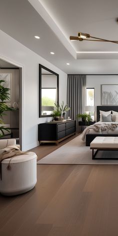 a modern bedroom with wood floors and white walls, along with a large bed in the center