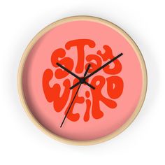 a clock with the words stay weird written in red on it's face and hands