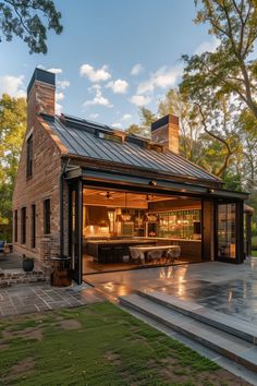 an open garage with stairs leading up to the front door and outside dining area in the background