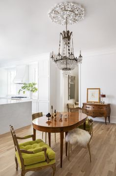 a dining room table with chairs and a chandelier