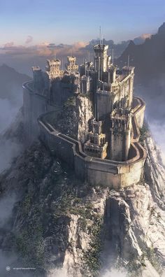 a castle on top of a mountain surrounded by clouds