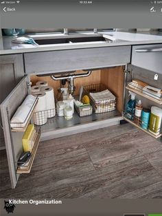 an open cabinet in the middle of a kitchen