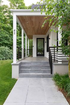 a porch with steps leading up to the front door